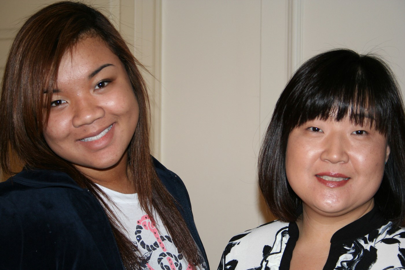 A student and Eika Hunt smile at a Center for Women at Work Event