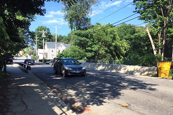 A car drives over the Pawtucket Canal bridge 