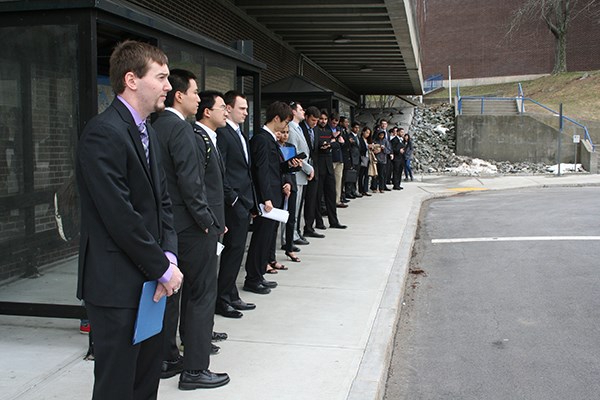 Students wait for a bus to the career fair on North Campus