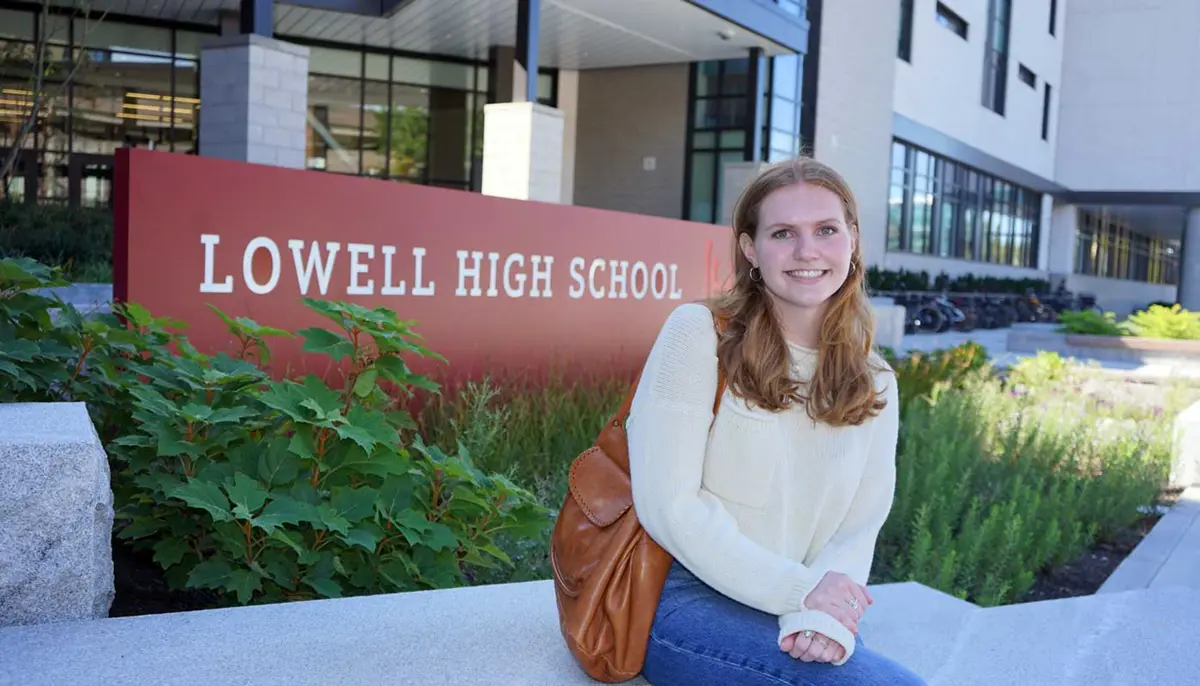 Celia Hoffman sits outside the Lowell High School building.