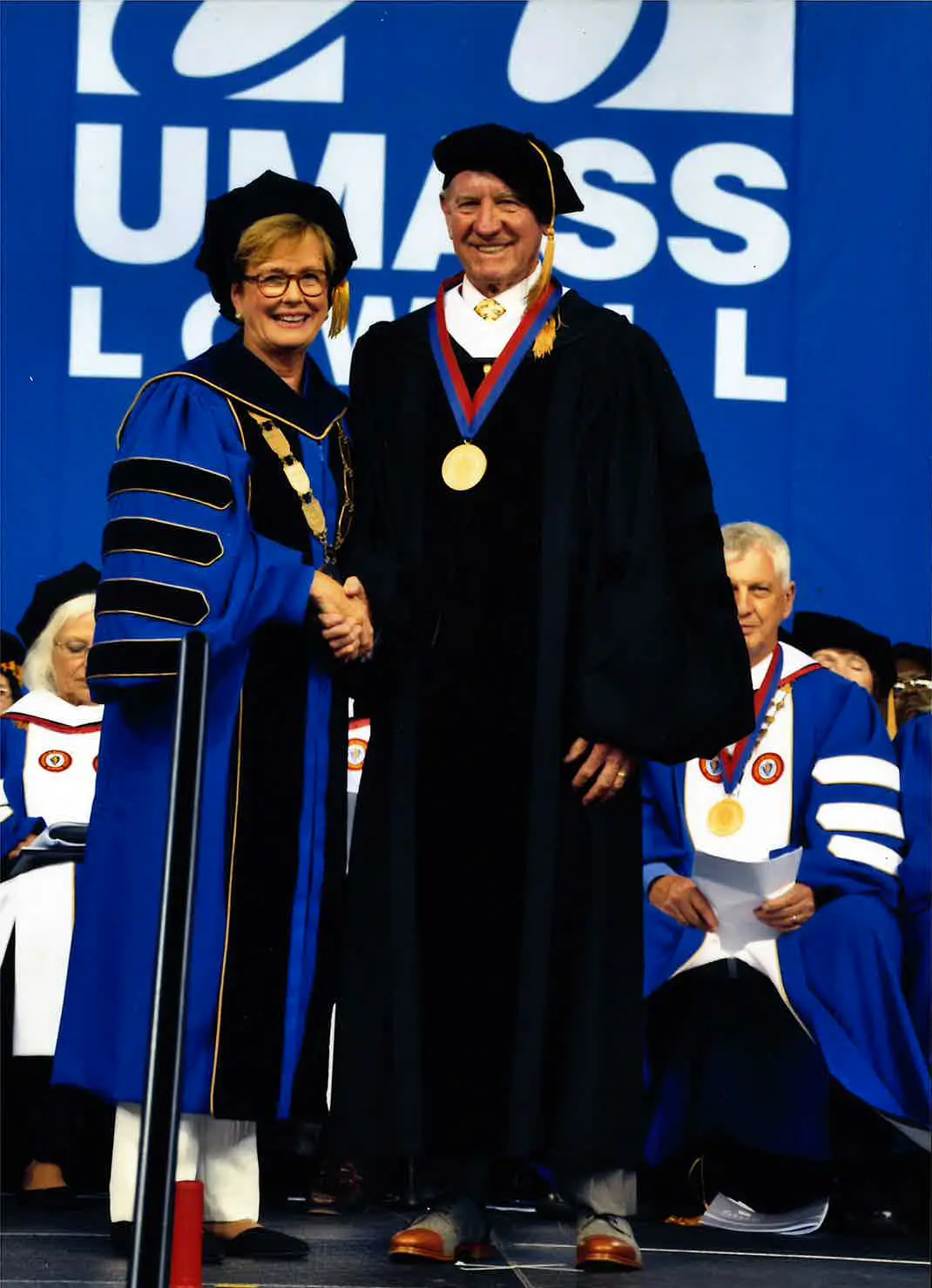 Jack O’Connor (right) receiving UMass Lowell’s Chancellor's Medal from Jacqueline Moloney in 2019.