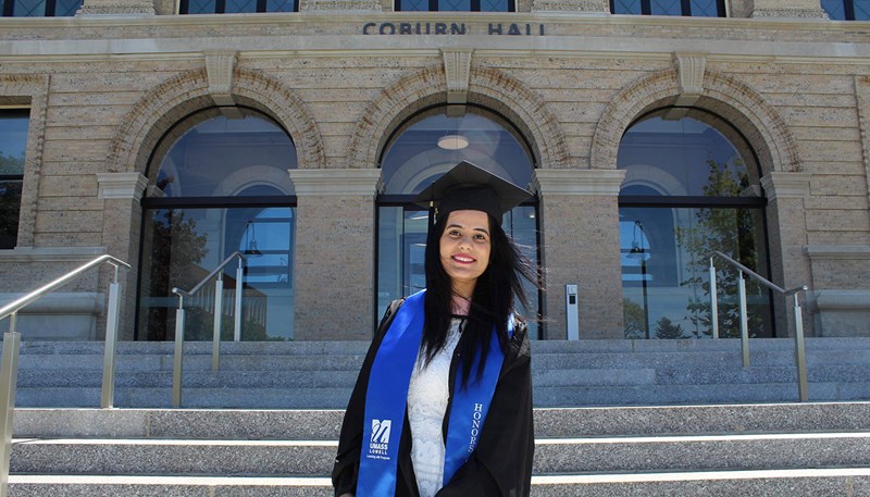 Chandni Shahdev in front of Coburn Hall in UMass Lowell south campus