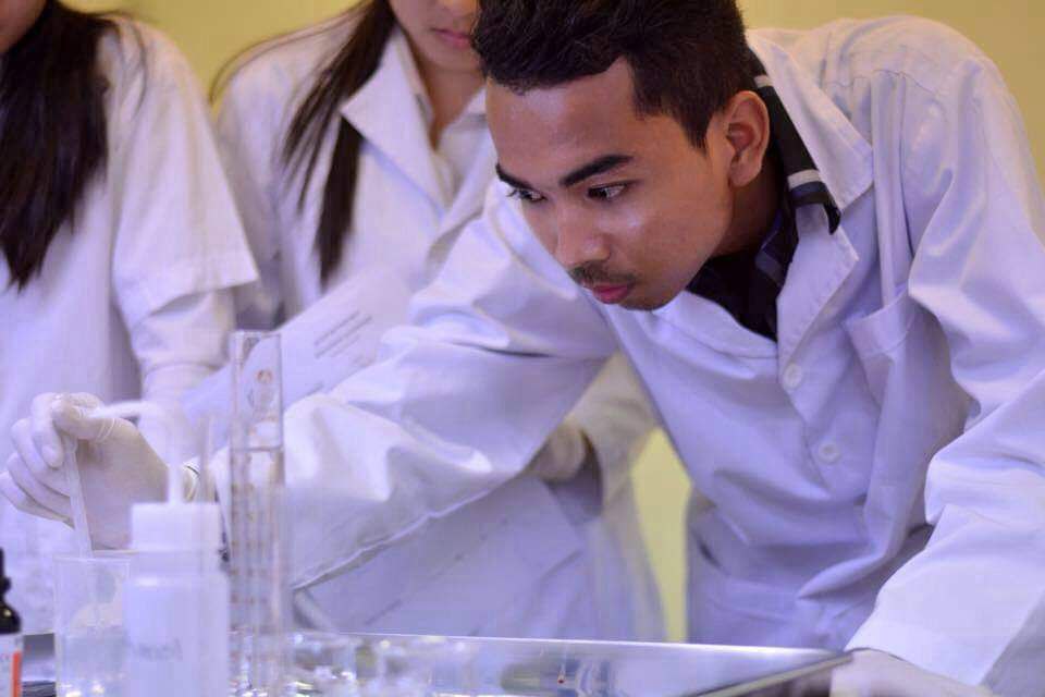 The photo taken in 2016 shows Chanvong Kul diluting the solution for an experiment at the University of Puthisastra, Phnom Penh, Cambodia. Photo provided by Chanvong Kul and taken by Malen Ea.