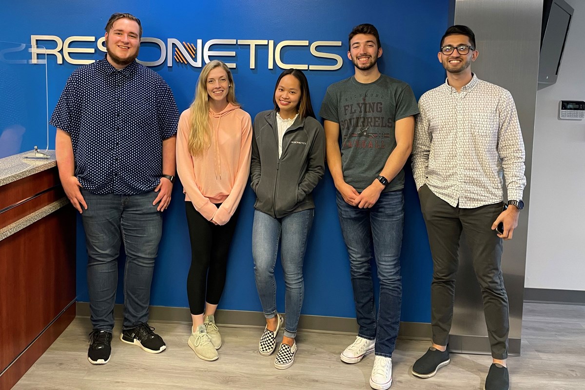 2022 graduate Minh Pham poses with other interns at the company Resonetics