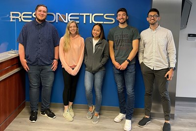 2022 graduate Minh Pham poses with other interns at the company Resonetics