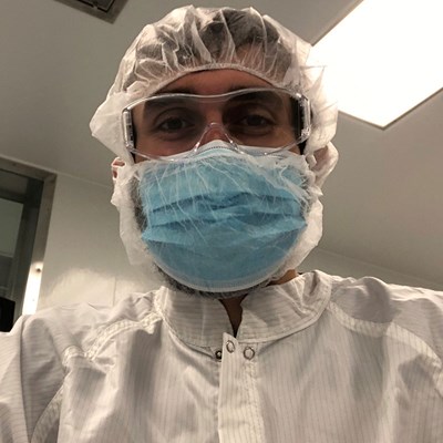 Michael Baltayan wearing lab gear for a clean room.