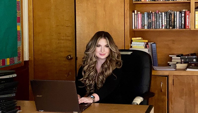 Christina Sirignano seated at a desk in an office