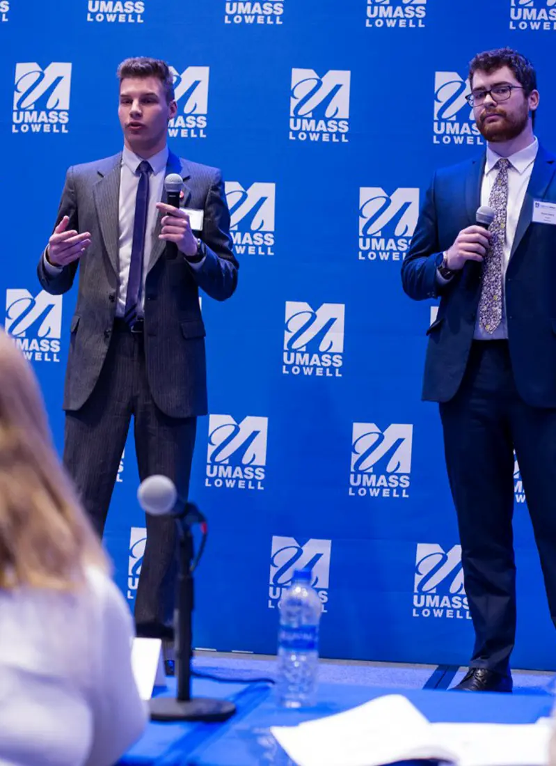 Nicholas Norcross and Kevin Seery onstage presenting ClassRoots to a panel of judges