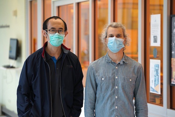 Asst. Prof. Man Hoi Wong and Ph.D. student Alexander Senckowski outside the clean room
