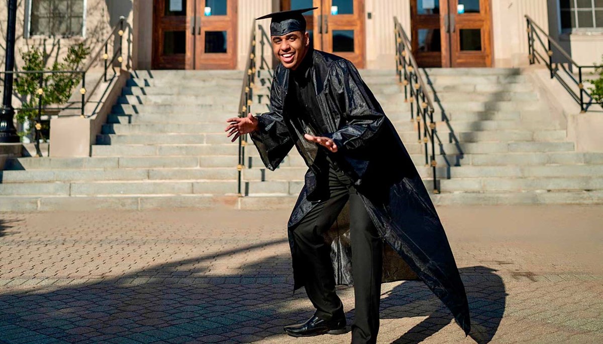 Cleidir Mendes poses in his graduation cap and gown