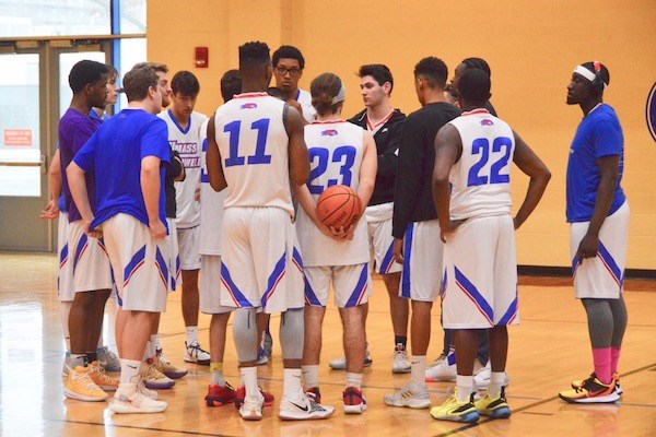 Players huddle up on the court at the Rec Center