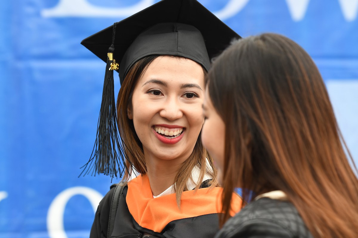 A happy woman graduate from the UMass Lowell 2018 Commencement ceremony