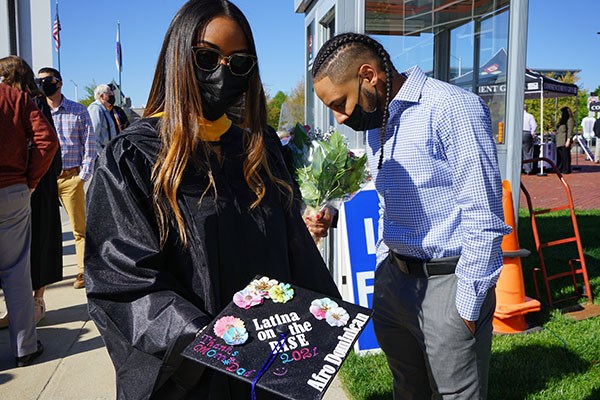 Melissa Antigua shows off her mortarboard at Commencement 2021