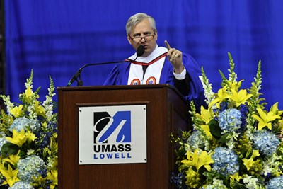 A happy woman graduate from the UMass Lowell 2018 Commencement ceremony