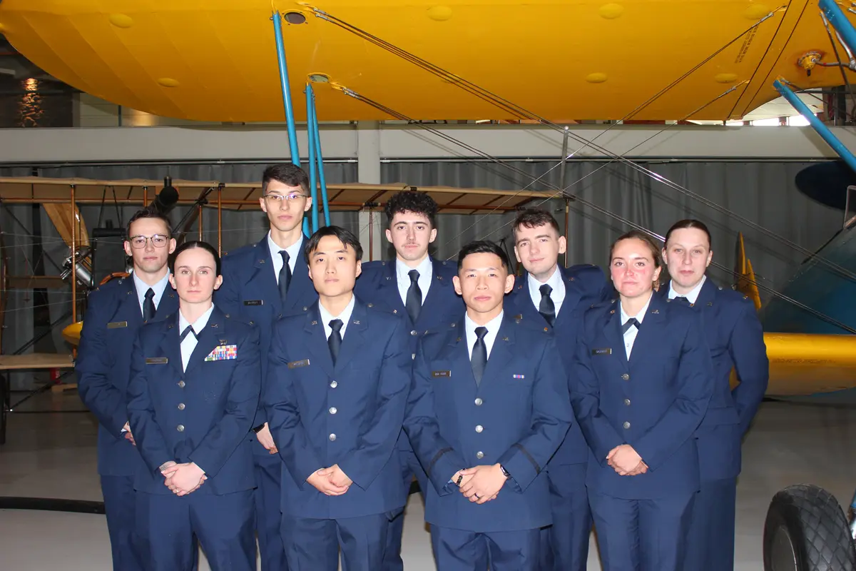 Cadets from 2025 stand in a airplane hanger during their commissioning.