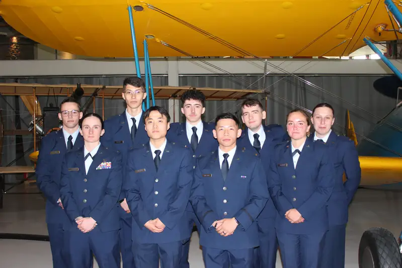 Cadets from 2025 stand in a airplane hanger during their commissioning.