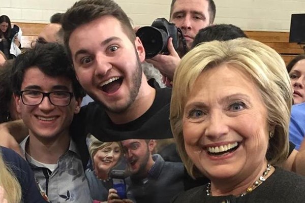 David Todisco takes a selfie with Hillary Clinton, wearing a t-shirt he made from a previous selfie with the candidate