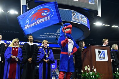 Rowdy waves a UML flag on the Convocation stage