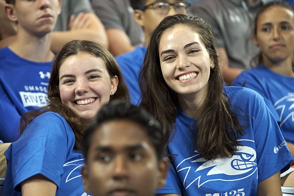 Two students smile for the camera at Convocation