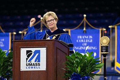 Chancellor Jacquie Moloney pumps her fist on the Convocation stage