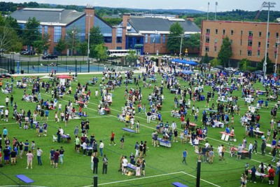 An elevated view of students at the engagement fair on the turf recreation fields