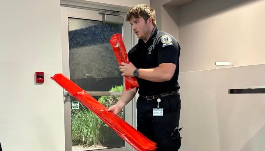 Cooper Ferrari holding splint boards, which are used to immobilize a fractured bone.