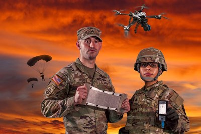Two military personnel wearing camouglage surrounded by new technologies with a sunset background.