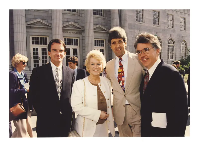 Carole Cowan in front of the newly restored Federal Building on Merrimack Street with Jay Linnehan, John Kerry, and Marty Meehan.