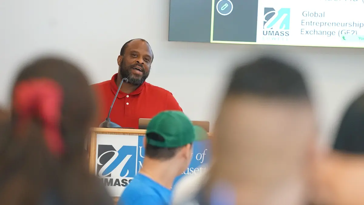 Crosby Newbill speaks from a UMass Lowell lectern.