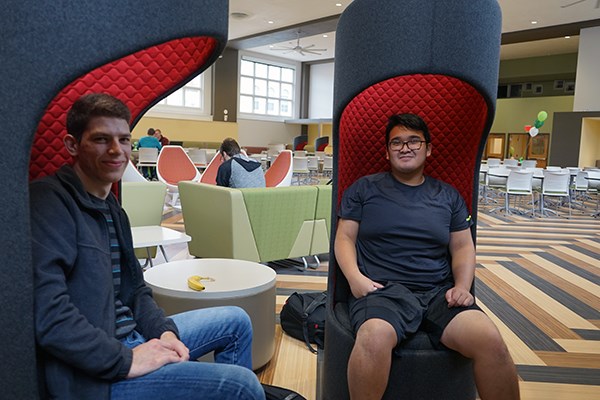 Students sit in designer chairs at the marketplace