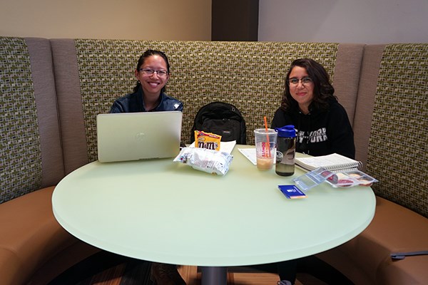 Students study in a corner booth