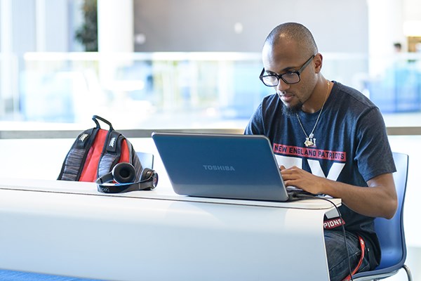 A student works on his laptop at the McGauvran Center