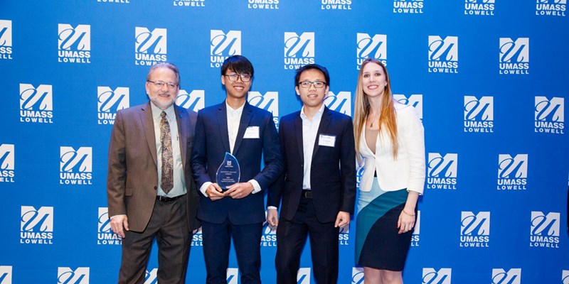 Thanh Hoang and Trung Nguyen onstage with Steve Tello, Holly Butler and their “ Innovative Technology Solution” award at the 2018 DifferenceMaker Idea Challenge, a $4,500 prize they are using towards DEXTER, the pesticide-spraying robot