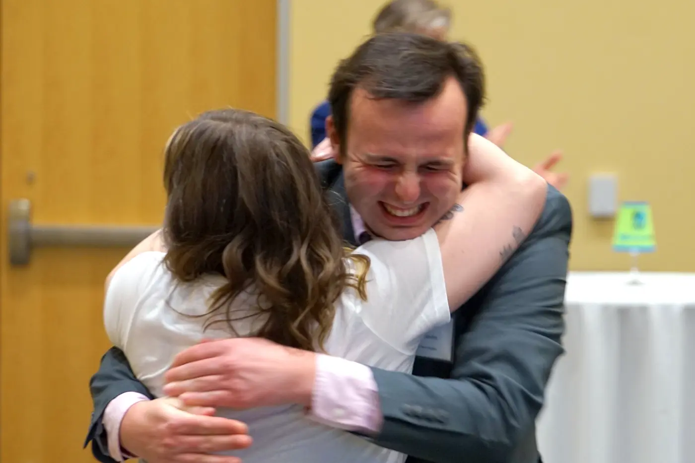 Two people hug in celebration.