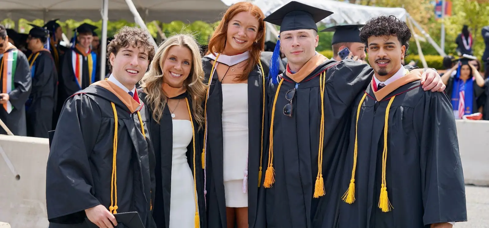 5 happy graduates in regalia 