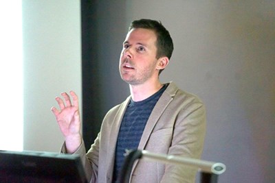 Jonathan Monaghan discusses his work at a recent presentation. His exhibit runs through Nov. 21 at University Gallery.