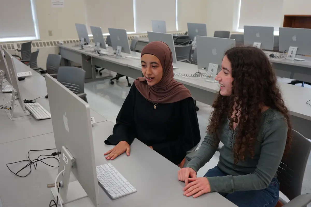 Two students sitting at a computer. 