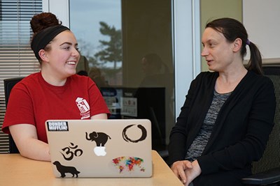 UML honors student Abby Colangelo looks over data with her honors fellowship mentor, Assoc. Prof. Ashleigh Hillier in psychology