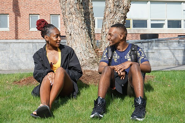 First-year UMass Lowell students Nicquela Roach (left) and Corey Sanon chat after class