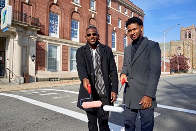 UMass Lowell graphic design senior Jason Reyes (right) and Michael Bastien formed a nonprofit to undertake positive actions in their hometown of Lawrence. The first project is a Black Lives Matter street mural, which will be painted on Lawrence Street later this month..
