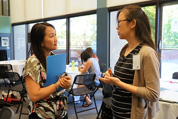 UMass Lowell Assoc. Prof. of Education Phitsamay Uy talks with Lilia Cai-Hurteau, a member of the 2018 cohort for the Ed.D. Leadership in Schooling online degree