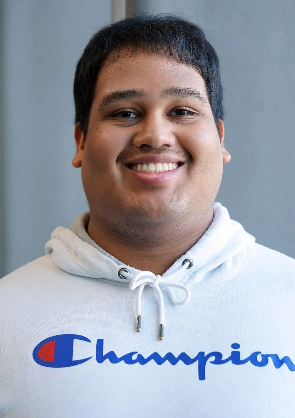Adolfo Gonzalez Mateo wearing a "Champion" sweatshirt.