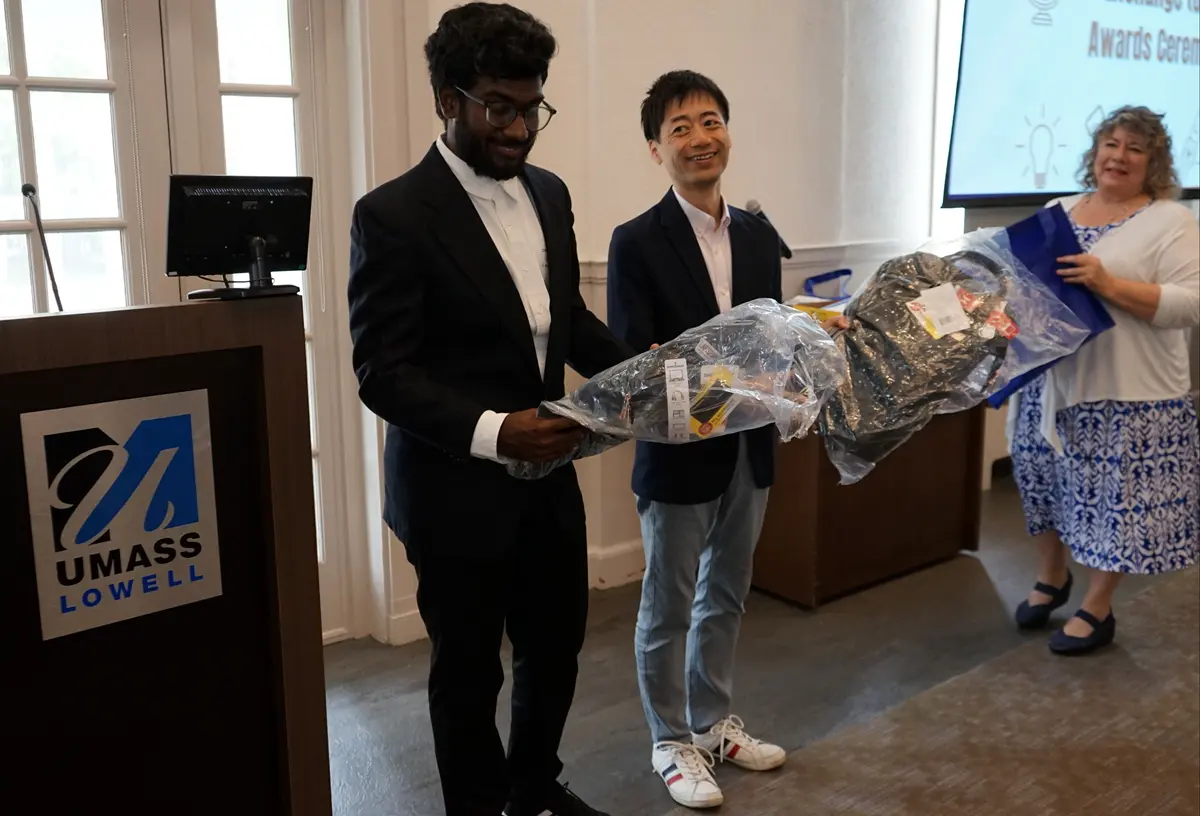 GE2 winners (Toshio Naito, right, and Gireesh Kalluri) receiving backpacks as their gift for winning the pitch contest.