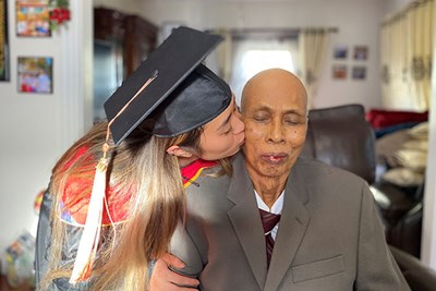 UML nursing student Darany Long kisses her grandfather, Saran Yous