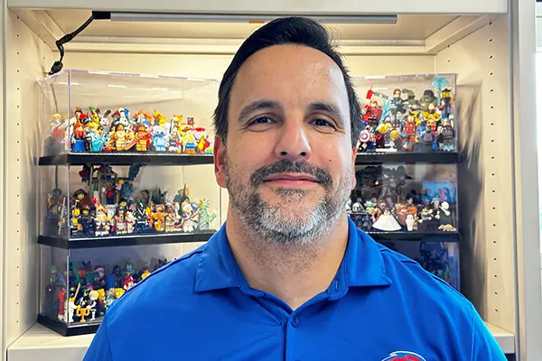 David Claudio in front of the Lego collections he displays in his office