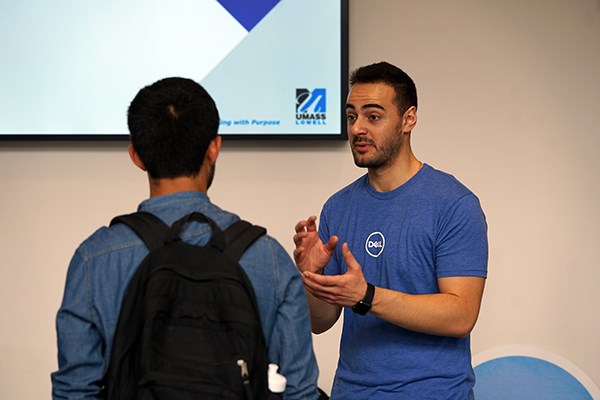 Engineering alum Nabil Saleh talks to a student about Dell