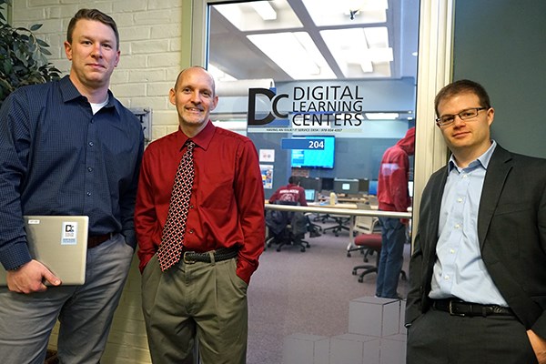 Information Technology staff members stand outside a Digital Learning Center
