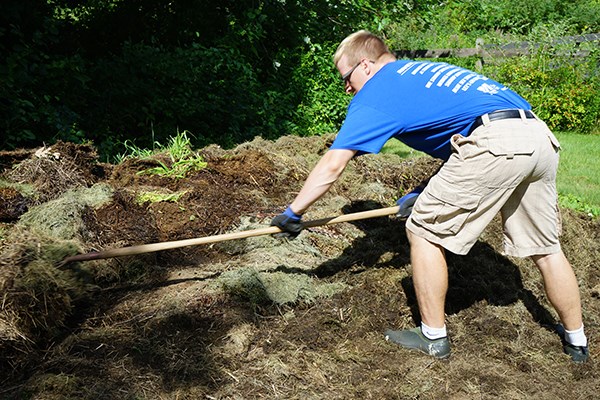 UMass Lowell student Tyler Lagasse turns over his compost pile