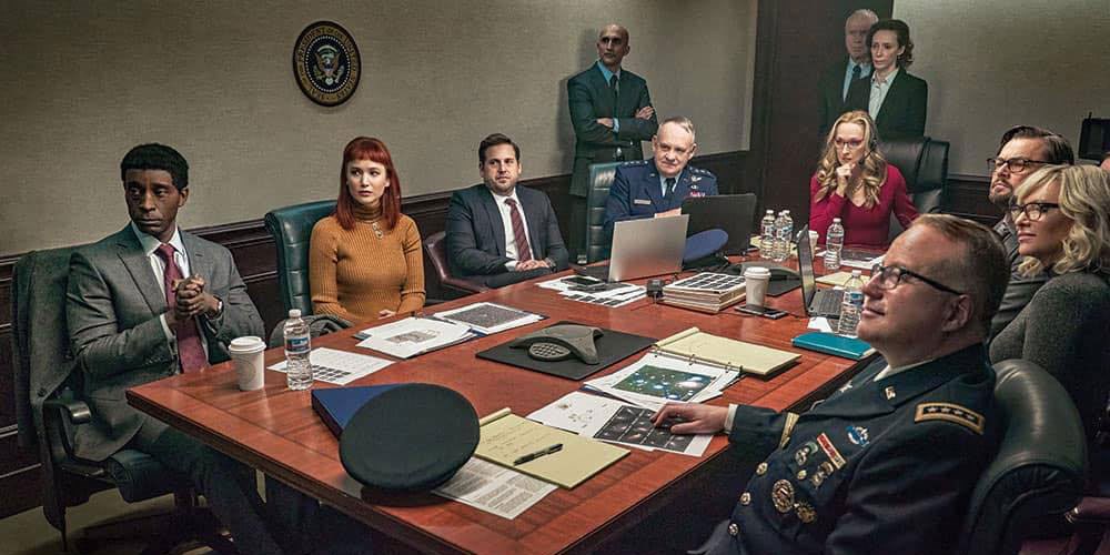 Actors dressed as politicians and military personnel around a conference table in "Don't Look Up"