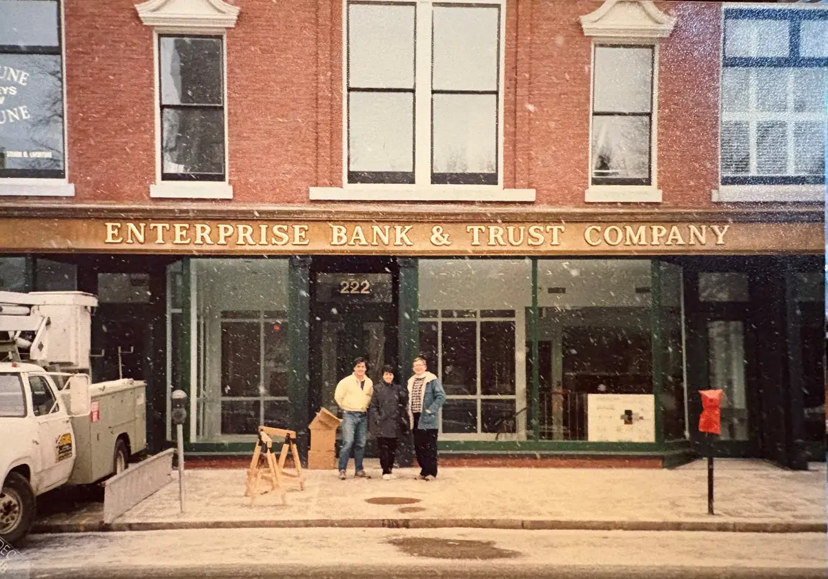 George Duncan, Jack Clancy, and Carole McOsker in front of Enterprise Bank & Trust Company in December 1988.
